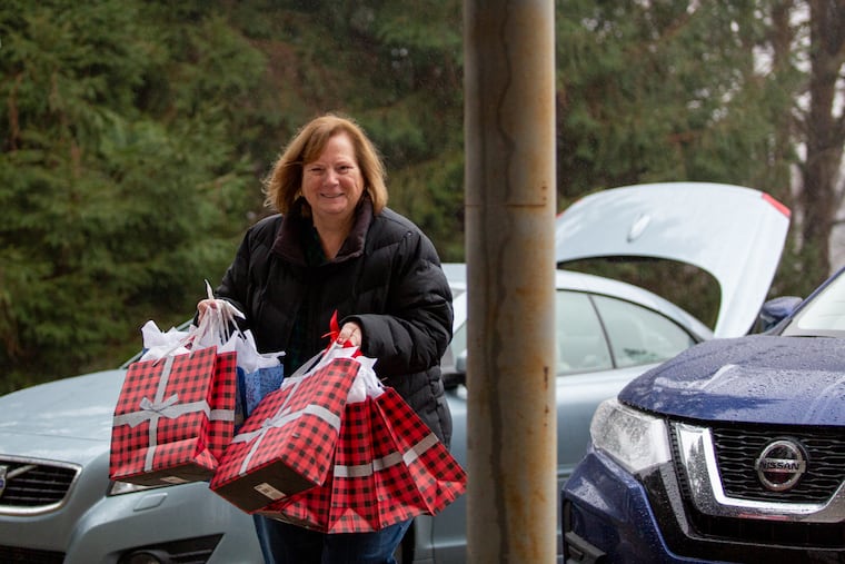 Mary Lou Zwaan delivers gift bags to Bill Zwaan Jr.'s office at West Chester. The extended Zwaan family are a big part of West Chester University's efforts to support homeless college students over the holiday break.