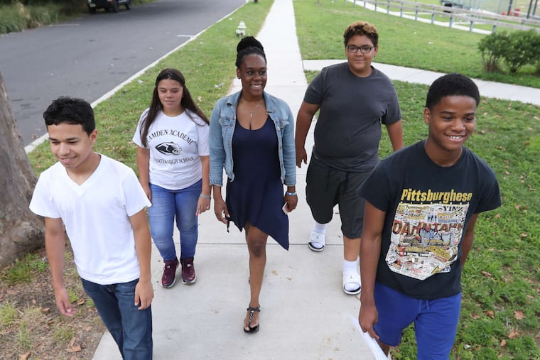 (From left) Christian Romero, Angie Muniz, Jeniya Webbs (academic success coach), Jahmir Coleman, and Naji Land walk through Pyne Point Park using maps and websites.