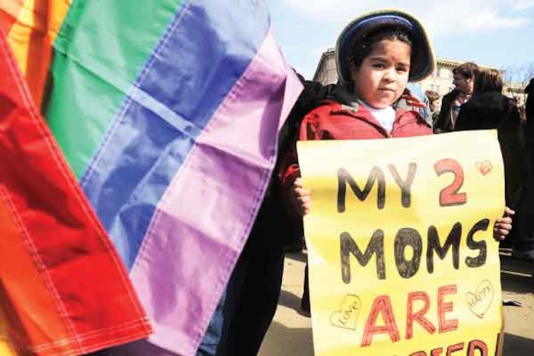 Demonstrators gather in front of the U.S. Supreme Court on Wednesday, March 27, 2013, as the court hers argments on a part of the 1996 Defense of Marriage Act that prevents legally wed same-sex couples from receiving certain benefits by defining marriage as between a man and woman. (Olivier Douliery/Abaca Press/MCT)