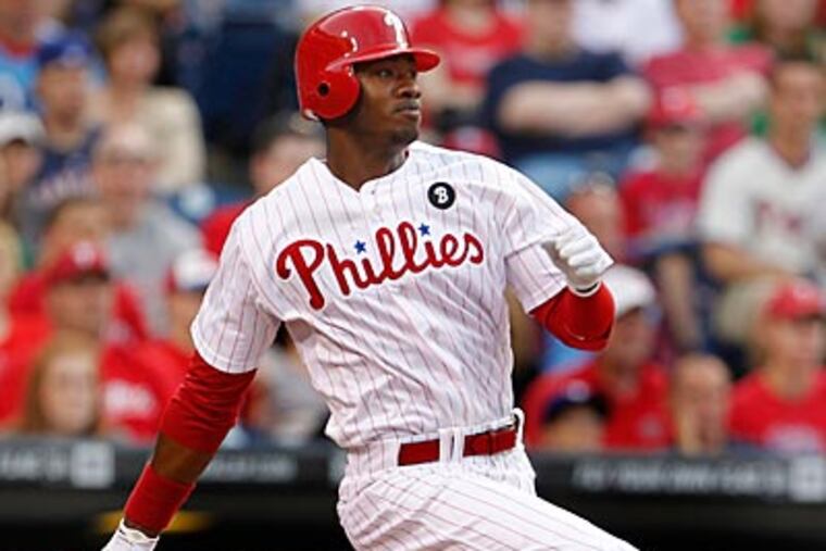 Domonic Brown is receiving outfield instruction from Juan Samuel. (Ron Cortes/Staff Photographer)