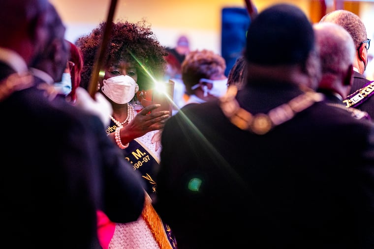 January 23, 2023: JoAnn Baldwin photographs the opening processional at the annual service commemorating the life of Rev. Dr. Martin Luther King, Jr. at Zion Baptist Church of Philadelphia on North Broad Street.