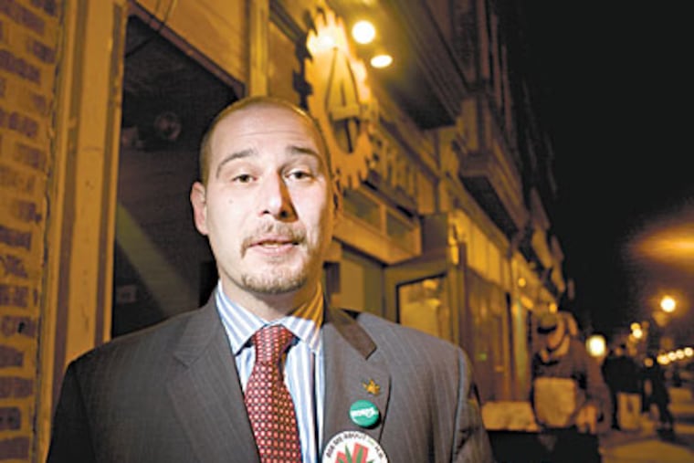 Chris Goldstein, communications director for PhillyNORML, a chapter of the National Organization for the Reform of Marijuana Laws, stands outside the A-Space in West Philly. (Ed Hille / Staff Photographer)