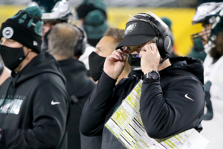 Eagles head coach Doug Pederson adjusts his glasses after the Eagles give up a touchdown in the third quarter as they play the Green Bay Packers at Lambeau Field in Green Bay, Wis. on December 6, 2020.