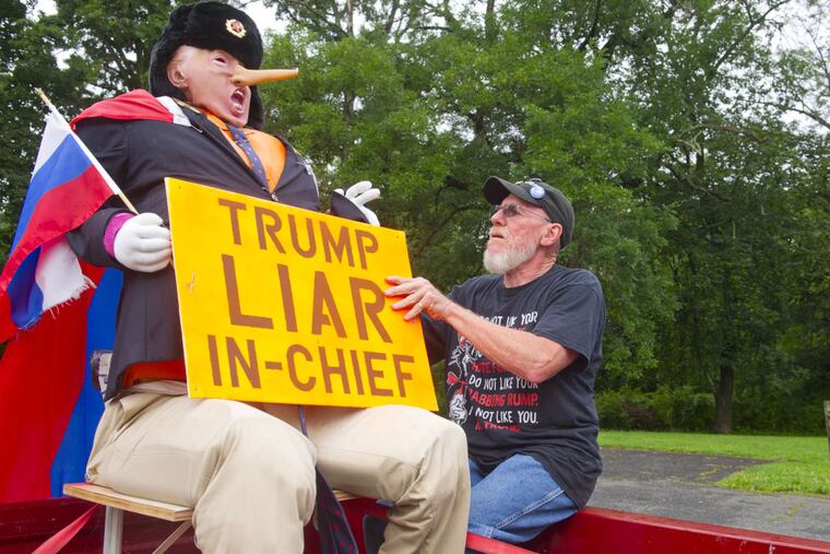 August 5, 2017 -- Jim Girvan of Branchburg, NJ, prepares his car as he and fellow Anti-Trump protesters gather in Bedminster Township, NJ to take part in a motorcade and protest against the president while he spends a two week vacation at his Trump National Golf Club in Bedminster. (Avi Steinhardt/ For the Philadelphia Inquirer)