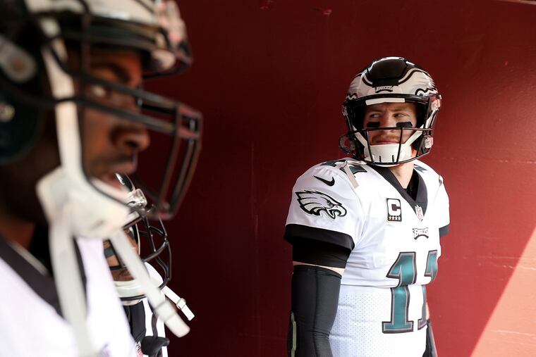 Carson Wentz (right) is ready to roll. Are the Eagles ready to roll with him?