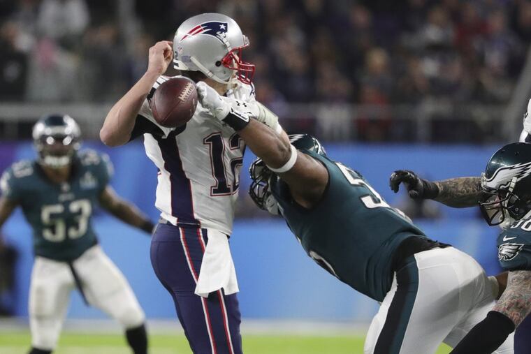 Eagles defensive end Brandon Graham forces a fumble on New England Patriots quarterback Tom Brady during the 4th quarter of Super Bowl LII, at U.S. Bank Stadium in Minneapolis, Minnesota.