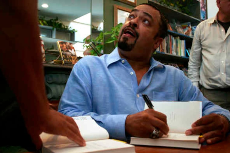 E. Lynn Harris signs a book at Giovanni's Room in 2006. The Philadelphia bookstore was one of the first to offer Harris a signing; later, when his works became best-sellers, the store was almost always a stop on his book tours.