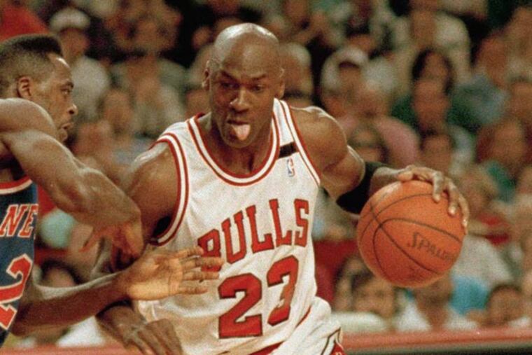 Michael Jordan, 23, drives on the New York Knicks' Gerald Wilkins during the first quarter of game seven of the Eastern Conference semi-finals in Chicago, May 17, 1992. (John Swart/AP file)