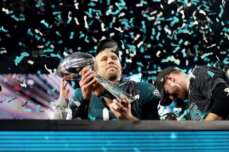 Eagles quarterback Nick Foles holds up the Lombardi trophy after Super Bowl LII, at U.S. Bank Stadium in Minneapolis, Minnesota, Sunday, Feb. 4, 2018. The Eagles won 41-33. TIM TAI / Staff Photographer