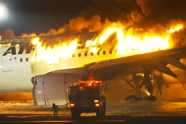 A plane engulfed in flames on the runway of Haneda Airport on Tuesday, Jan. 2, 2024, in Tokyo, Japan.