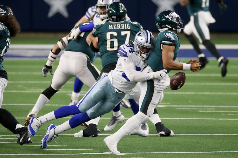 Dallas Cowboys defensive end Randy Gregory (94) sacks Eagles quarterback Jalen Hurts (2), forcing a fumble, in the third quarter of Sunday's game.