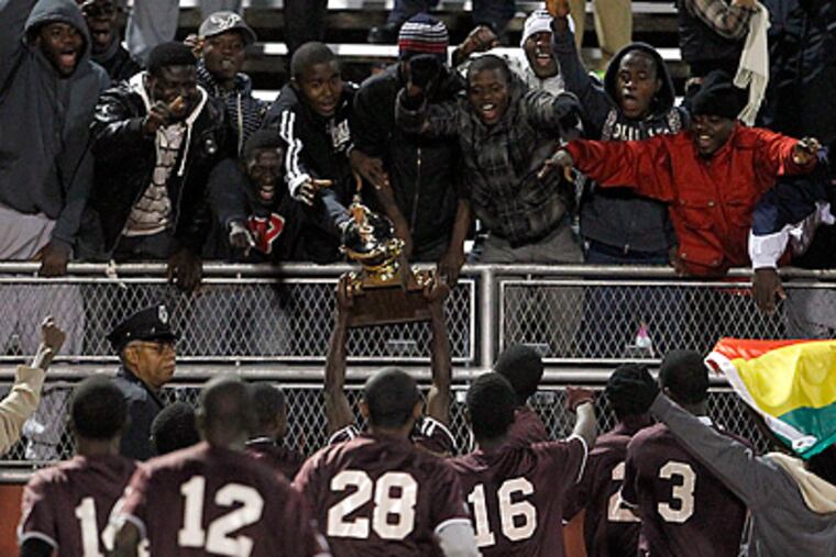 Bartram boy's soccer team celebrate their Public League soccer championship with. (Yong Kim / Staff Photographer)