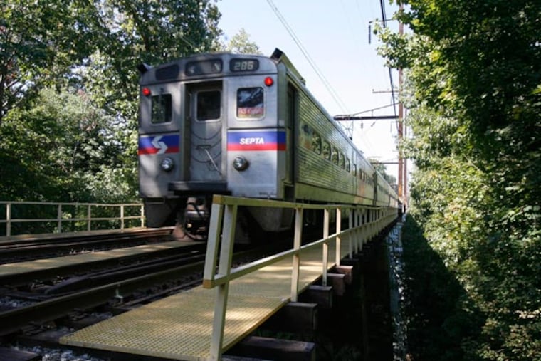 The SEPTA train passes over the bridge over Crum Creek in Swarthmore. (Charles Fox / Inquirer)