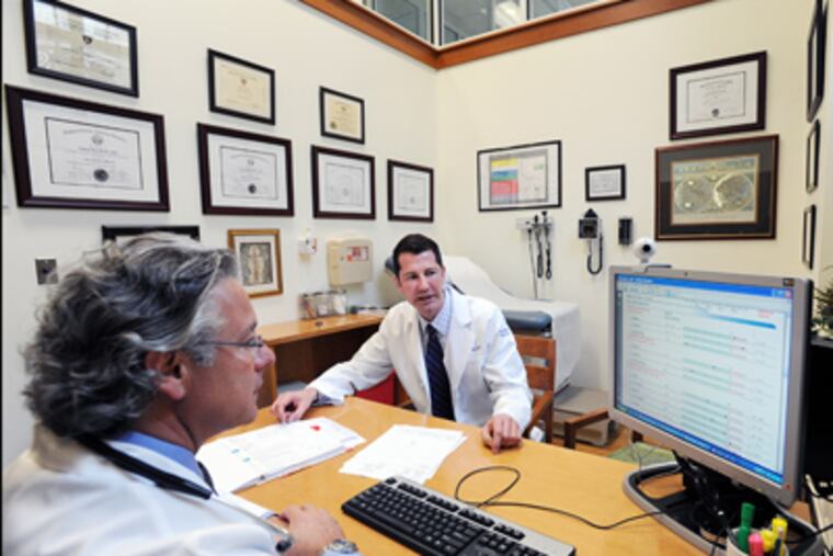 Anthony J. Bazzan (left), codirector, and Daniel A. Monti, director, of the Great Life Program, discuss a patient at Thomas Jefferson University
Hospital’s Myrna Brind Center of Integrative Medicine. (Sharon Gekoski-Kimmel / Staff Photographer)