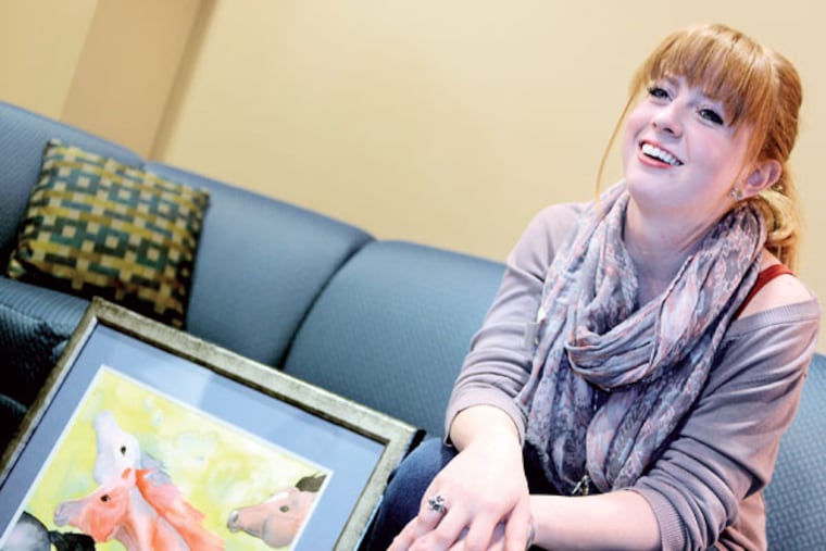 Jenna Bass talks on January 8, 2015, at the Renfrew Center of Southern New Jersey about how painting has provided her with an outlet. The work at left is titled "Souls on Fire." ( TOM GRALISH / Staff Photographer )