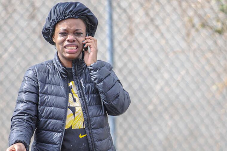 One of the victim's sisters reacts at the scene of the fatal shooting yesterday at Somerset Street and Park Avenue.