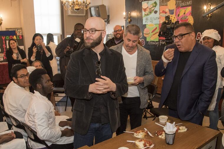 In a 2017 ceremony at Dobbins High, James Beard Award-winners (from left) Greg Vernick, Michael Solomonov, and Stephen Starr taste-test dishes made by students in the culinary-arts program.