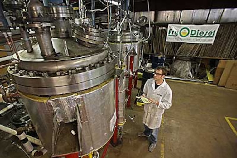 BlackGold BioFuels Pilot Plant plant engineer, Stephen Kasprzyk, records the temperatures in a Bio-fuel reaction vessel, an intermediate step in the process of converting trap grease into biofuel. ( David M Warren/ Staff Photographer )