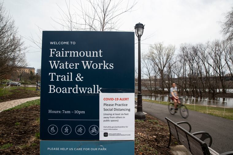 Philadelphia began closing its playgrounds Friday and installing signs warning people to exercise caution when they use the city's parks.