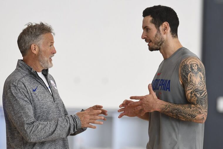 Coach Brett Brown (left) and new Sixers guard J.J. Redick chat during training camp last week.