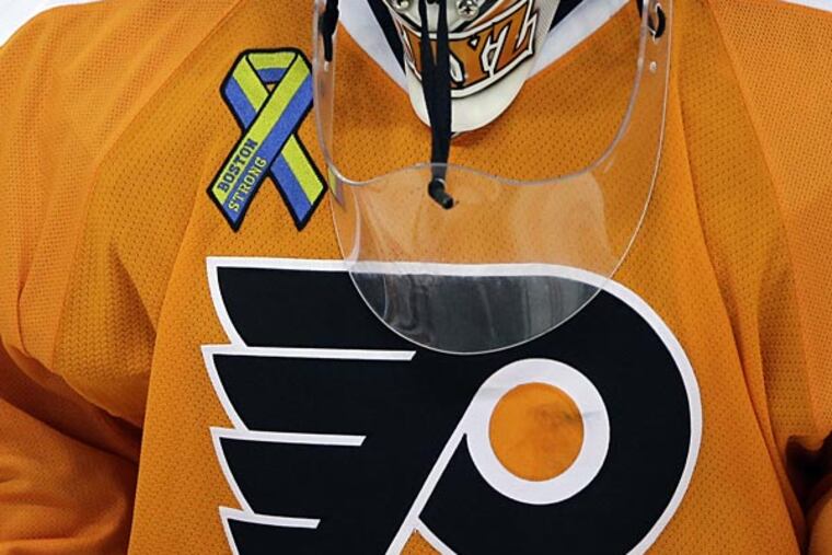 Philadelphia Flyers goalie Ilya Bryzgalov wears a Boston Strong patch on his uniform during warm-ups before an NHL hockey game against the Boston Bruins, Tuesday, April 23, 2013, in Philadelphia. (Matt Slocum/AP)