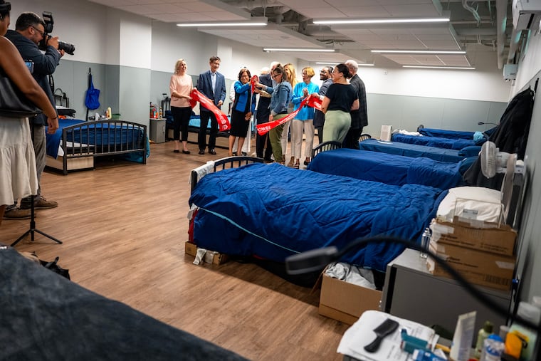 Staff and guests and donors and officials cut the ribbon at Hawthorne House Respite Wednesday June 24, 2026, a new Project HOME respite space with 34 beds for unhoused Philadelphians with medical needs that can't be addressed in the shelter system.