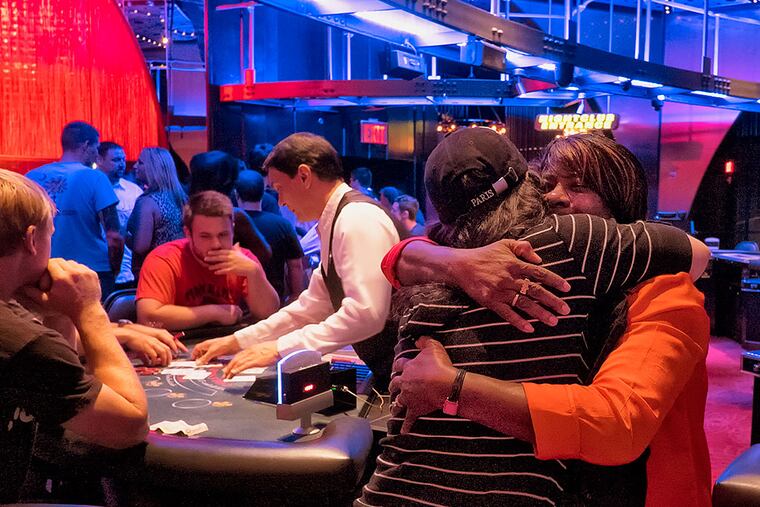 Christina Moffa, 2nd from right, general manager of Ivan Kane's Royal Jelly Burlesque Nightclub, and Katrina Wilson , a table games supervisor, embrace during the early morning hours before the close of Revel. The nightclub hosted a party for the casino workers.