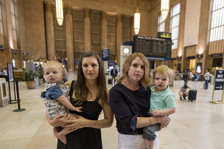 Lacey Kohlmoos (left) holding then-9-month-old Finn Heckert, and Samantha Matlin holding Logan Matlin, who was 21-month-old, in Amtrak’s 30th Street Station in August, after they started an online petition for Amtrak to provide places for nursing mothers to pump breast milk in 30th St. Station and Union Station in D.C. CLEM MURRAY / Staff Photographer