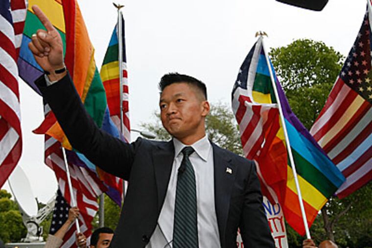 Former Army National Guard Lt. Dan Choi, an Arabic-speaking specialist dismissed through the 'Don't Ask, Don't Tell' policy, comments on Proposition 8, outside the Beverly Hills hotel, where U.S. President Barack Obama attended a benefit dinner in Beverly Hills, Calif. on Wednesday, May 27, 2009. (AP Photo/Damian Dovarganes)