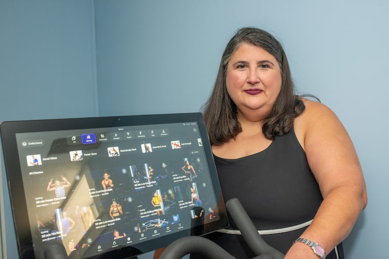 Psychologist Rachel Millner poses with her Peloton bicycle on Friday, October 24, 2025, at her home in Yardley.