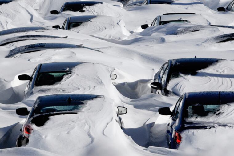 Snow begins to melt on cars parked at a dealership after a winter storm in Hartford, Conn., Sunday, Feb. 10, 2013. A howling storm across the Northeast left much of the New York-to-Boston corridor covered with more than three feet of snow on Friday into Saturday morning. (AP Photo/Jessica Hill)