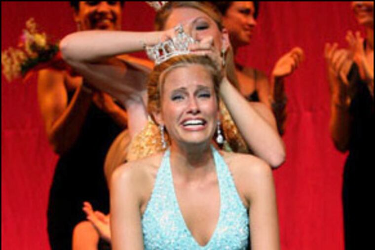 "It would certainly be easier for me to simply succumb to these unlawful and immoral threats, and quietly disappear," Miss New Jersey Amy Polumbo said today at a news conference she called in Asbury Park. Here she receives her crown during the June 16 event.