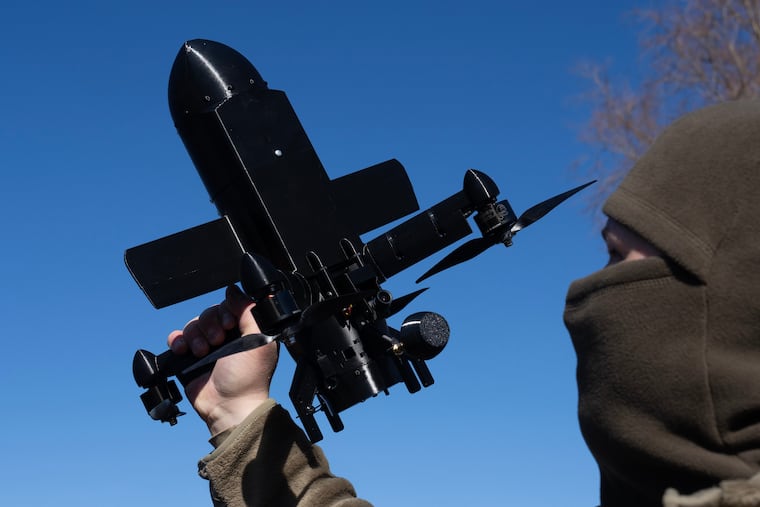FILE - An instructor from the Ukrainian company General Cherry demonstrates the operation of an anti-air interceptor drone designed to destroy Russian attack drones in Kyiv region, on March 11, 2026.