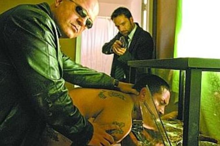 Michael Chiklis (left) portrays corrupt LAPD Detective Vic Mackey.