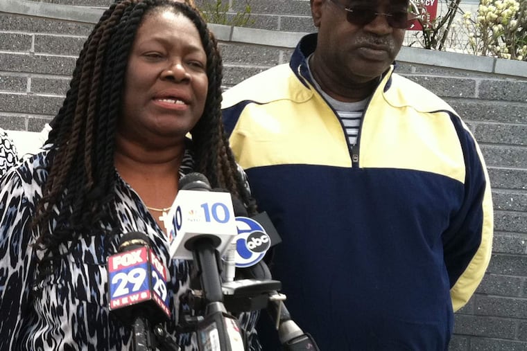 Channabel Latham-Morris urges the driver who hit her son, Jamal Morris, at 45th and Market Streets about 3:45 a.m. Saturday to surrender to police. Morris' father, Hector Charlton Morris (right), said his son fell in love with Philadelphia.