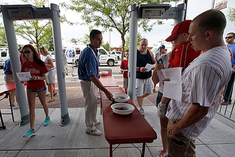 Fans enter Citizens Bank Park through metal detectors at the right field entrance. (Yong Kim/Staff Photographer)