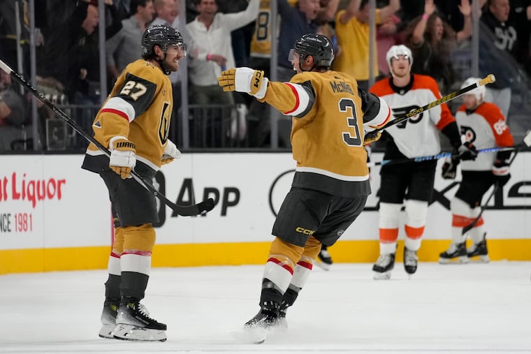 Shea Theodore (left) celebrates after scoring the game-winning goal for Vegas against the Flyers on Tuesday night.