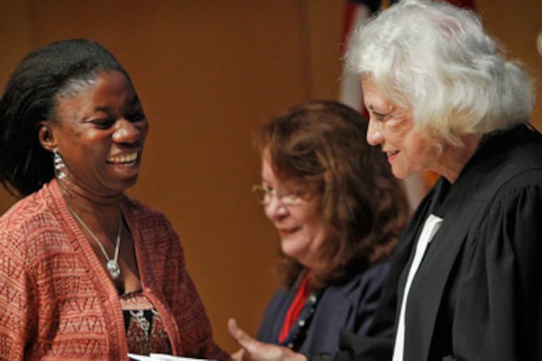 Odell M. Washington an immigrant from Liberia, greets retired Supreme Court Justice Sandra Day O'Connor. Naturalized citizens of the United States of America were sworn in today at the National Constitution Center, September 16, 2011. (Alejandro A. Alvarez / Staff Photographer)