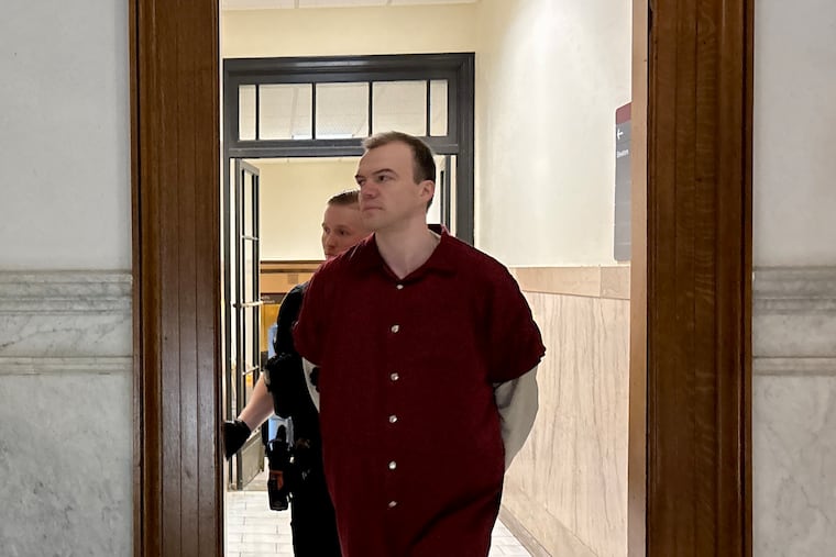 Stephen Kamnik is escorted into a courtroom in the Montgomery County Courthouse on Wednesday.