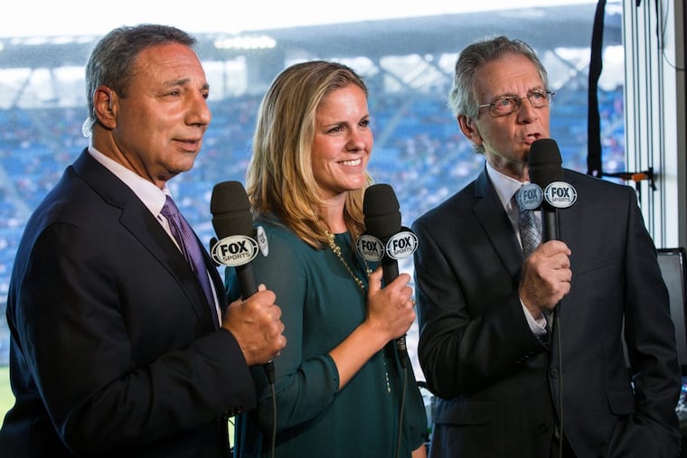 JP Dellacamera (right) will broadcast his ninth men’s World Cup and 14th overall this summer, when he travels to Russia for Fox Sports. He is pictured here working at a U.S. women’s national team game alongside Cat Whitehill (center) and the late Tony DiCicco.
