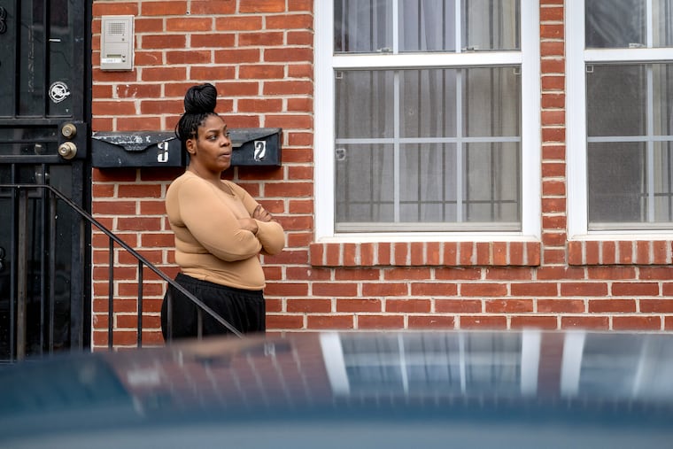 Shanese Dutton outside her apartment on North 18th Street near Temple University in February. She is living in a building headed for foreclosure, after being sold at a wildly inflated price that required an outsized mortgage.