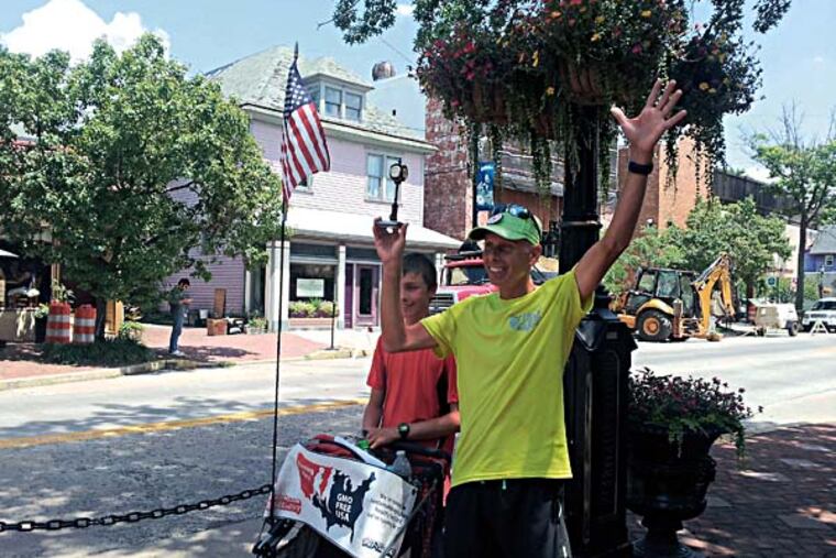 Father and son, Brett and David Wilcox, pose for pictures in Collingswood after running from the Liberty Bell in Philadelphia, over the Ben Franklin bridge and through Camden. The two are running to Ocean City from the Los Angeles area to raise awareness of GMO labelling.