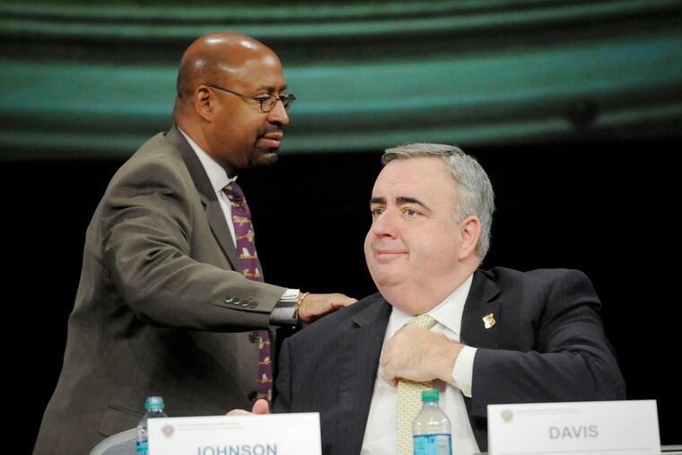Mayor Nutter pats Boston Police Commissioner Edward Davis on the back after he addressed the International Associations of Chiefs of Police conference at the Pennsylvania Convention Center.