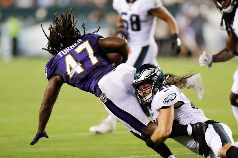 Eagles linebacker Alex Singleton stops Baltimore Ravens running back De'Lance Turner in a preseason game. Singleton says he has been cut seven times in the NFL.
