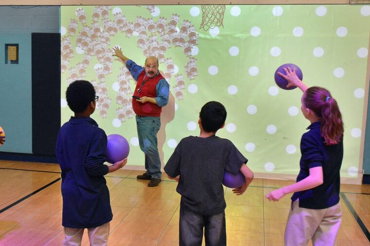 Valley Day School Education Director Ron Hall instructs students as they take part in activities in the Lu Interactive Playground at the school in Morrisville Pa. MARK C. PSORAS/For the Inquirer