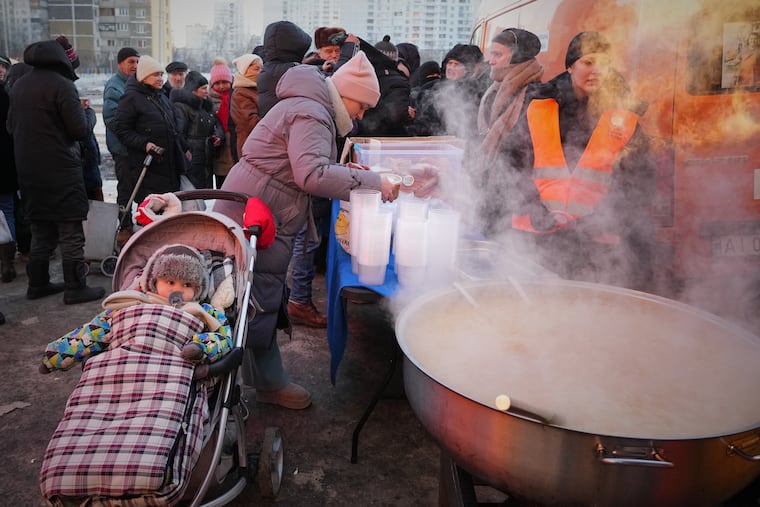 Yuliia Dolotova, 37, receives hot food at a distribution point during a power outage caused by Russia’s repeated air strikes on the country’s power grid, in Kyiv, Ukraine, on Monday.
