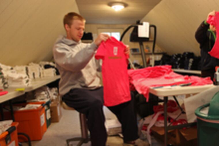 Tim Lawson and Amy Levine , hired when the company's sales took off, inspect and sort T-shirts at Save 2nd Base.