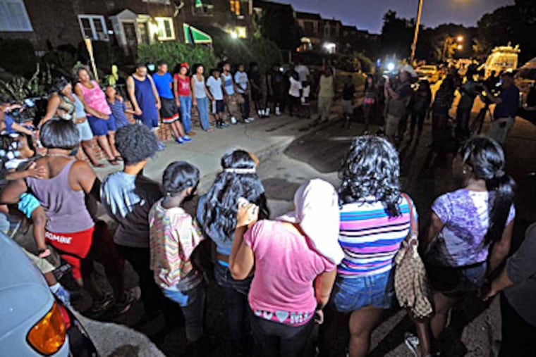 Dozens of neighbors and family members gathered at the scene where 13- and 17-year-old brothers were fatally shot inside a home in the 1300 block of Westbury Drive in Philly's Overbrook Park section. (Photo / Tom Kelly IV)
