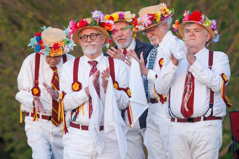 Members of Kingsessing Morris Men, applaud performers with Dances for a New Day at Philadelphia's Belmont Plateau on Friday to mark May Day. Kingsessing Morris Men and Renegade Morris take to the plateau each year to greet the spring planting season.