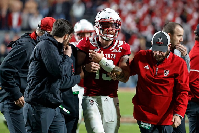 North Carolina State quarterback Devin Leary (13) is assisted off the field by medical staff during the second half of the team's NCAA college football game against Florida State in Raleigh, N.C., Saturday, Oct. 8, 2022.